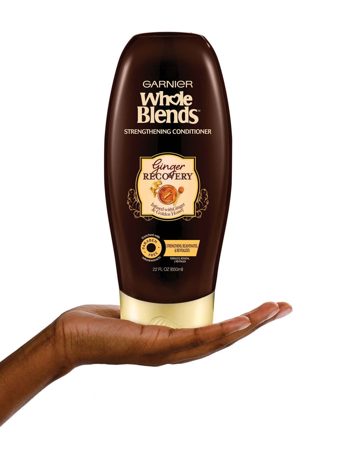 Hand holding Whole Blends Ginger Recovery Strengthening Conditioner 22oz.